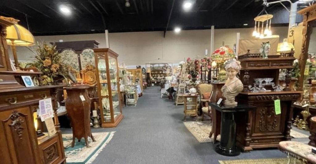 The interior of a spacious antique shop in Texas, featuring rows of vintage wooden furniture.