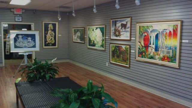 An interior view of the Gilmer Arts Center gallery featuring several framed paintings a Hidden Gem in Gilmer